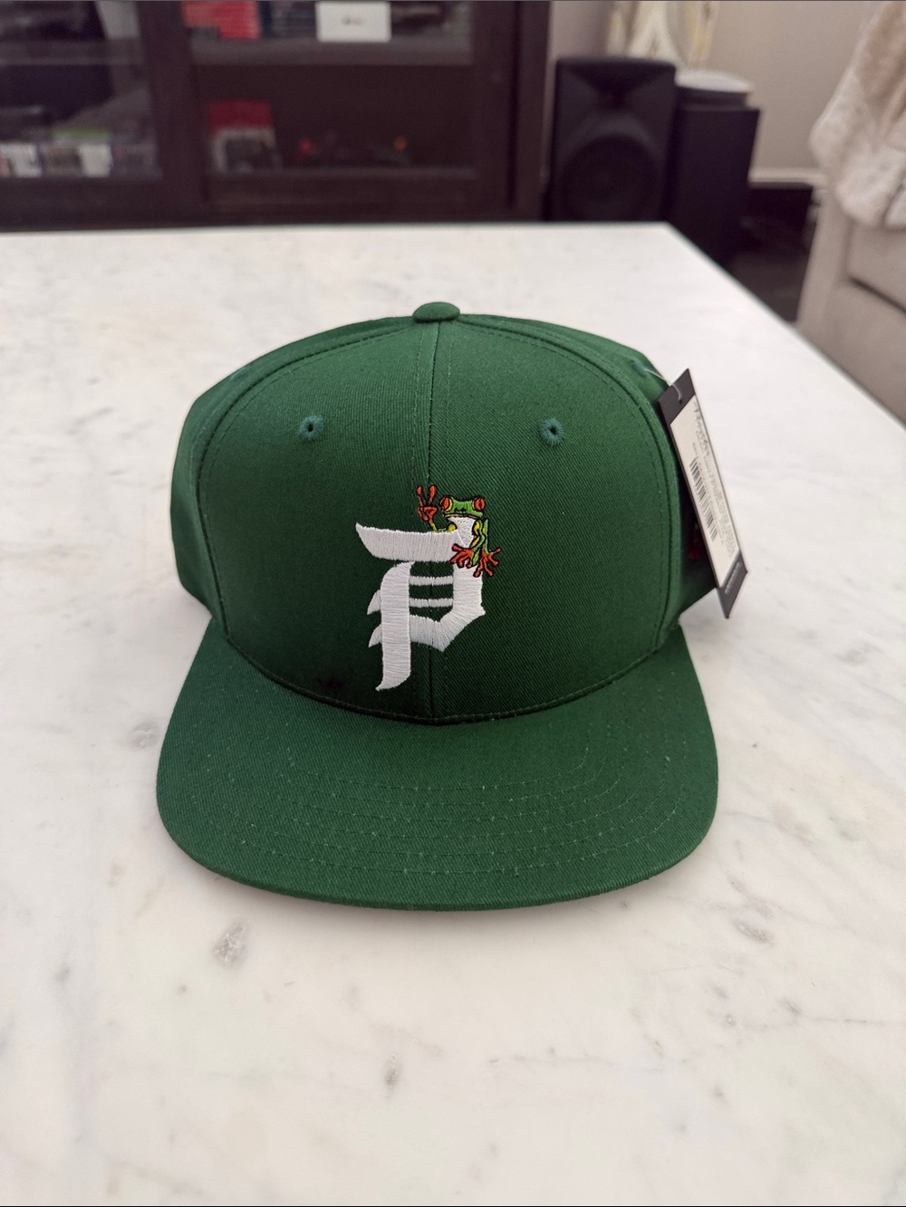 Primitive Green Flat Brim Hat with White P Logo and Floral Accent